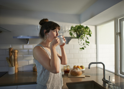 a woman drinking coffee in the morning 